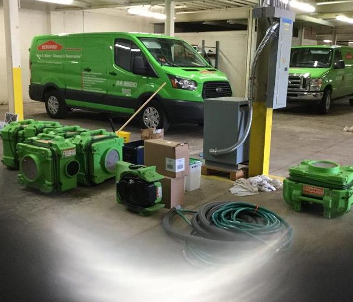 SERVPRO equipment and vehicles in a warehouse. 