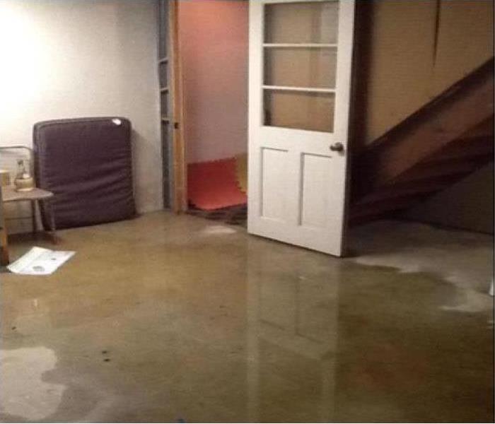 A basement floor covered in water  