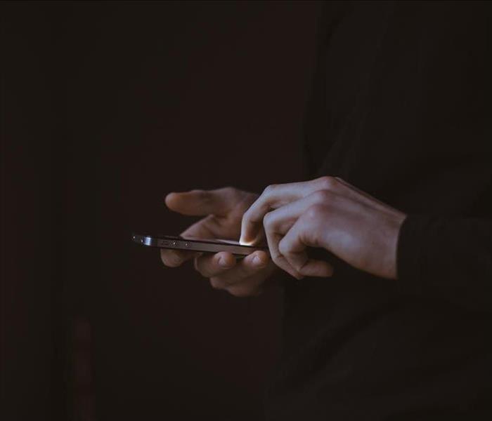 hands of a man using an electronic device